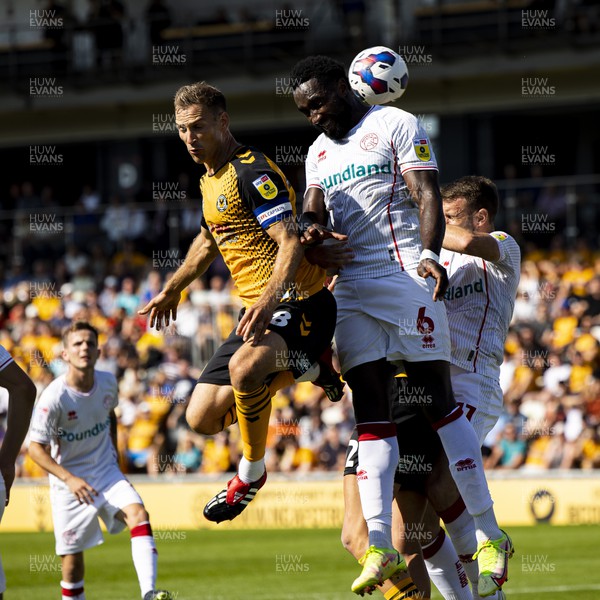 050822 - Newport County v Walsall - Sky Bet League 2 - Mickey Demetriou of Newport County in action against Emmanuel Monthe of Walsall