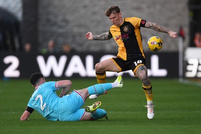 081125 - Newport County v Walsall - Sky Bet League 2 - Kai Whitmore of Newport County is challenged by Connor Barrett of Walsall