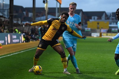 081125 - Newport County v Walsall - Sky Bet League 2 - Bobby Kamwa of Newport County is challenged by Ryan Finnigan of Walsall