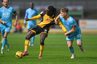 081125 - Newport County v Walsall - Sky Bet League 2 - Cameron Antwi of Newport County is challenged by Lewis Warrington of Walsall