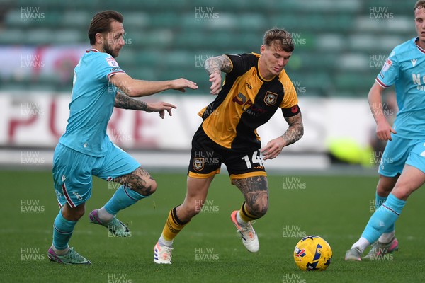 081125 - Newport County v Walsall - Sky Bet League 2 - Kai Whitmore of Newport County is challenged by Charlie Lakin of Walsall