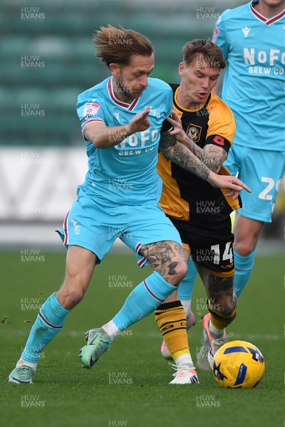 081125 - Newport County v Walsall - Sky Bet League 2 - Kai Whitmore of Newport County is challenged by Charlie Lakin of Walsall