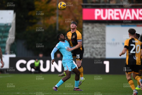 081125 - Newport County v Walsall - Sky Bet League 2 - Lee Jenkins of Newport County is challenged by Daniel Kanu of Walsall
