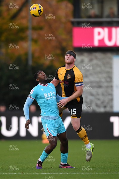 081125 - Newport County v Walsall - Sky Bet League 2 - Lee Jenkins of Newport County is challenged by Daniel Kanu of Walsall