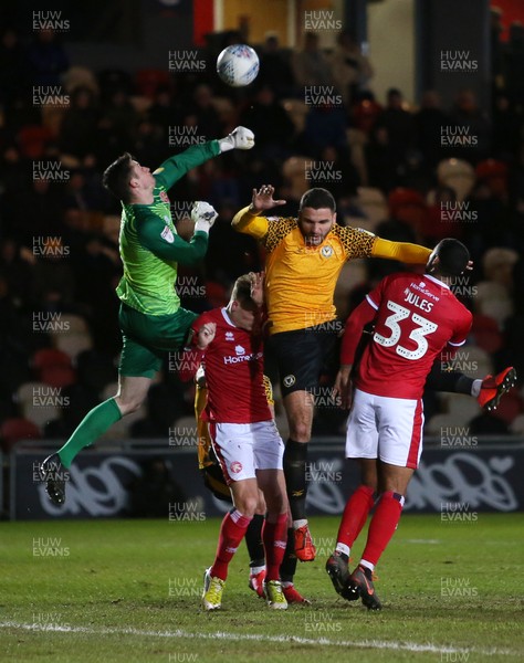 110220 - Newport County v Walsall - SkyBet League Two - Ryan Innis of Newport County is beaten to the ball by keeper Liam Roberts of Walsall