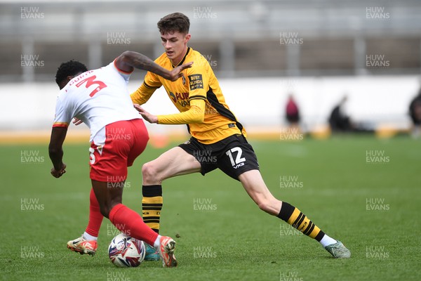 210425 - Newport County v Walsall - Sky Bet League 2 - Joe Thomas of Newport County is challenged by Liam Gordon of Walsall
