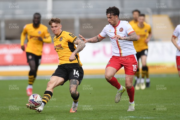 210425 - Newport County v Walsall - Sky Bet League 2 - Kai Whitmore of Newport County is challenged by Alfie Chang of Walsall