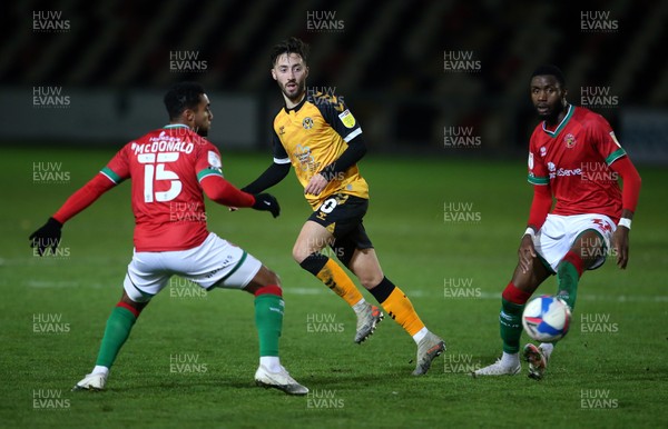 241120 - Newport County v Walsall - SkyBet League Two - Josh Sheehan of Newport County is challenged by Wes McDonald and Emmanuel Osadebe of Walsall