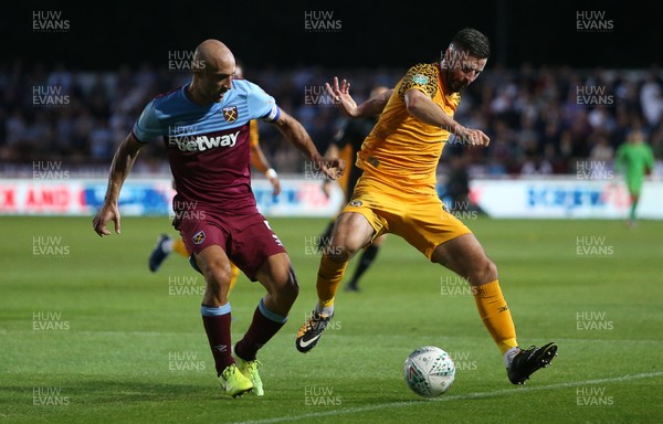 270819 - Newport County v West Ham United - Carabao Cup - Padraig Amond of Newport County is challenged by Pablo Zabaleta of West Ham