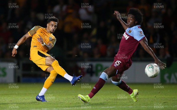270819 - Newport County v West Ham United - Carabao Cup - Corey Whitely of Newport County fires a shot past Carlos Sanchez of West Ham