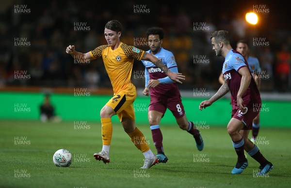 270819 - Newport County v West Ham United - Carabao Cup - Taylor Maloney of Newport County is challenged by Jack Wilshere of West Ham