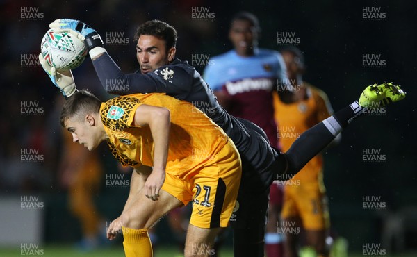270819 - Newport County v West Ham United - Carabao Cup - Roberto of West Ham crashes over Taylor Maloney of Newport County