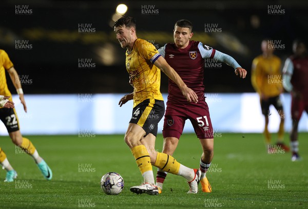 311023 - Newport County v West Ham United U21s - Carabao Cup - Ryan Delaney of Newport County is challenged by Daniel Chesters of West Ham