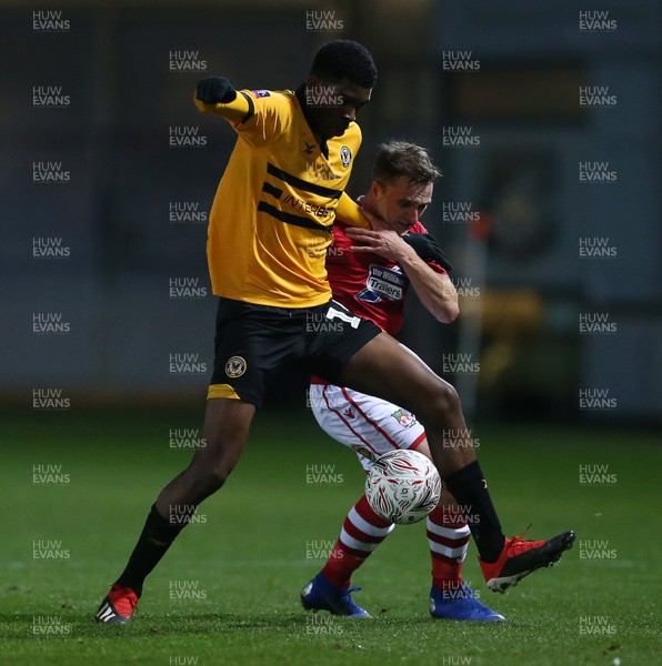 111218 - Newport County v Wrexham AFC - FA Cup Second Round Replay - Tyreeq Bakinson of Newport County is challenged by Paul Rutherford of Wrexham