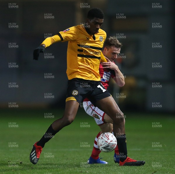 111218 - Newport County v Wrexham AFC - FA Cup Second Round Replay - Tyreeq Bakinson of Newport County is challenged by Paul Rutherford of Wrexham