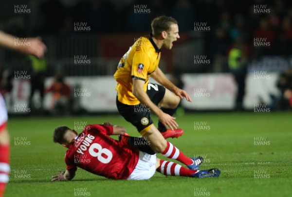 111218 - Newport County v Wrexham, FA Cup Round 2 Replay - Luke Young of Wrexham is shown a red card for this tackle on Mickey Demetriou of Newport County