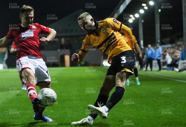 111218 - Newport County v Wrexham, FA Cup Round 2 Replay - Dan Butler of Newport County crosses as Paul Rutherford of Wrexham challenges