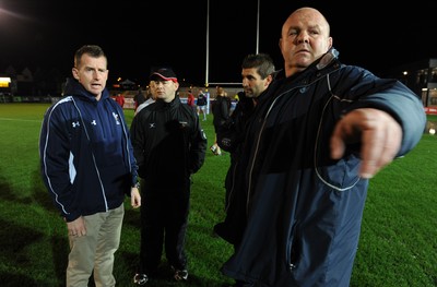 04.11.11 - Newport-Gwent Dragons v Cardiff Blues - RaboDirect PRO12 - Referee Nigel Owens talks Dragons coach Darren Edwards and Cardiff Blues coaches Gareth Baber and Justin Burnell on the water logged pitch at Rodney Parade. 