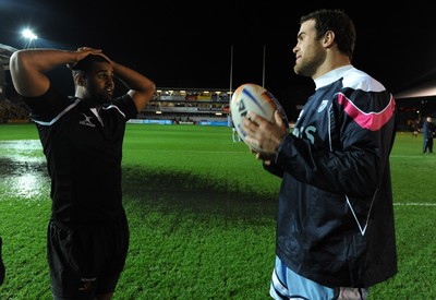 04.11.11 - Newport-Gwent Dragons v Cardiff Blues - RaboDirect PRO12 - Aled Brew of Dragons and Jamie Roberts of Cardiff Blues on the water logged pitch at Rodney Parade. 