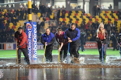 04.11.11 - Newport-Gwent Dragons v Cardiff Blues - RaboDirect PRO12 - Fans and officials try to clear the water logged pitch at Rodney Parade. 