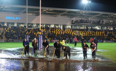 04.11.11 - Newport-Gwent Dragons v Cardiff Blues - RaboDirect PRO12 - Fans and officials try to clear the water logged pitch at Rodney Parade. 