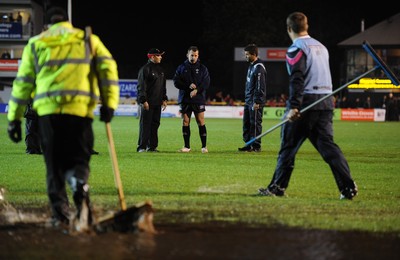 04.11.11 - Newport-Gwent Dragons v Cardiff Blues - RaboDirect PRO12 - Referee Nigel Owens(c) discusses the water logged pitch at Rodney Parade with Dragons coach Darren Edwards and Blues coach Gareth Baber(R) before the game is postponed. 