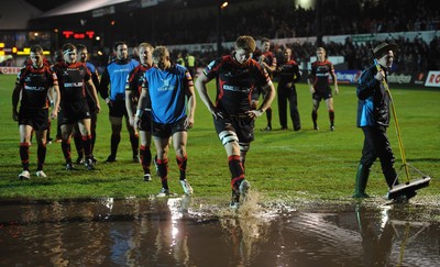 04.11.11 - Newport-Gwent Dragons v Cardiff Blues - RaboDirect PRO12 - Dragons players look at the water logged pitch at Rodney Parade after the game is postponed. 