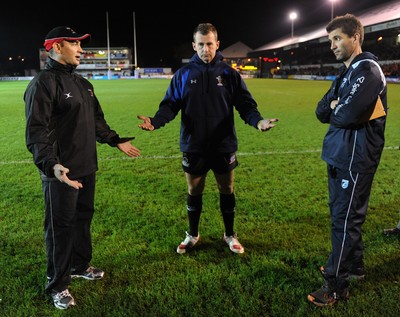 04.11.11 - Newport-Gwent Dragons v Cardiff Blues - RaboDirect PRO12 - Referee Nigel Owens(c) discusses the water logged pitch at Rodney Parade with Dragons coach Darren Edwards and Blues coach Gareth Baber(R) before the game is postponed. 