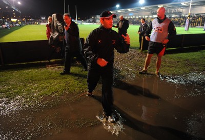 04.11.11 - Newport-Gwent Dragons v Cardiff Blues - RaboDirect PRO12 - Dragons coach Darren Edwards leaves the water logged pitch at Rodney Parade after the game is postponed. 