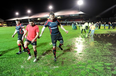 04.11.11 - Newport-Gwent Dragons v Cardiff Blues - RaboDirect PRO12 - Scott Morgan leaves the water logged pitch at Rodney Parade after the game is postponed. 