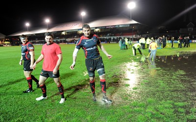 04.11.11 - Newport-Gwent Dragons v Cardiff Blues - RaboDirect PRO12 - Scott Morgan leaves the water logged pitch at Rodney Parade after the game is postponed. 