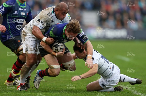 261215 - Newport Gwent Dragons v Cardiff Blues - Guinness PRO12 - Lewis Evans of Newport Gwent Dragons is tackled by Taufa'ao Filise and Jarrod Evans of Cardiff Blues