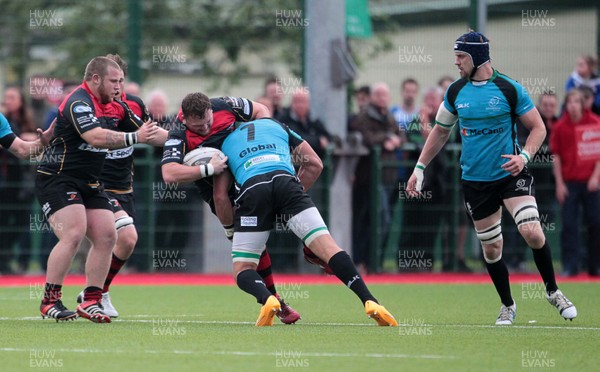 140815 - Newport Gwent Dragons v Nottingham - Pre Season Friendly - Luke Garrett of Newport Gwent Dragons is tackled by Rob Langley of Notthingham