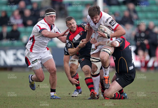 080315 - Newport Gwent Dragons v Ulster - Guinness PRO12 - Iain Henderson of Ulster is taken down by Dorian Jones and Thomas Rhys Thomas of Dragons