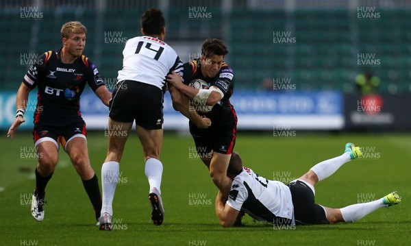 090916 - Newport Gwent Dragons v Zebre - Guinness PRO12 - Sam Beard of Newport Gwent Dragons is tackled by Lloyd Greeff and Giulio Bisegni of Zebre