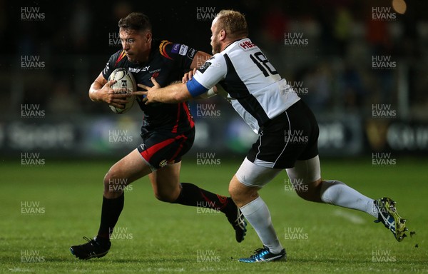 090916 - Newport Gwent Dragons v Zebre - Guinness PRO12 - Charlie Davies of Newport Gwent Dragons is tackled by Dario Chistolini of Zebre