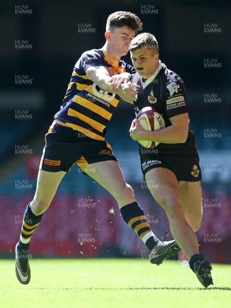 230416 - WRU - Bowl Final - Burry Port v Newport HSOB - Ryan Richards of Burry Port is tackled by James McCarthy of Newport