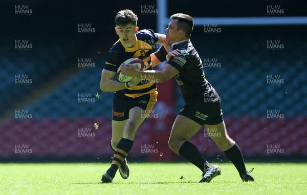 230416 - WRU - Bowl Final - Burry Port v Newport HSOB - James McCarthy of Newport is tackled by Morgan Hand of Burry Port