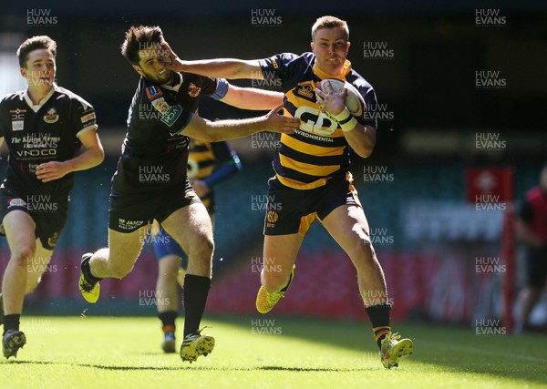 230416 - WRU - Bowl Final - Burry Port v Newport HSOB - Thomas Rogers of Newport is tackled by Elis Staines of Burry Port