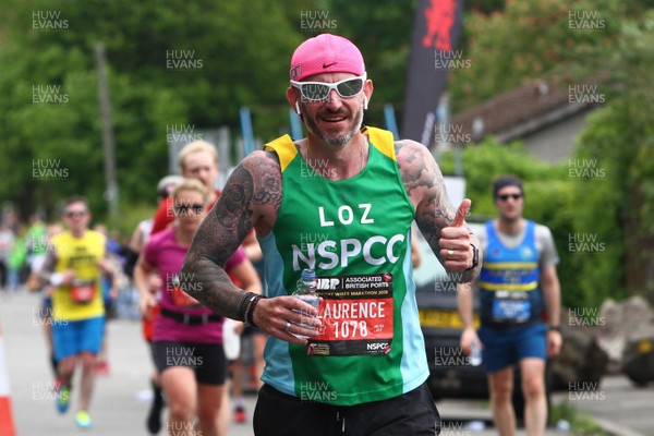 050519 - Newport Wales  Marathon and 10K - Newport Marathon runner for NSPCC passes the 24 mile marker at The Transporter Bridge 