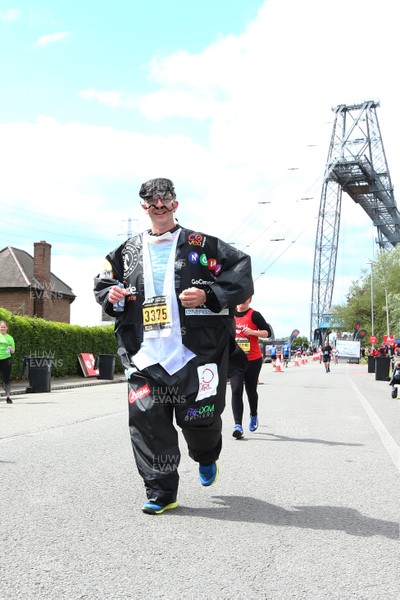 050519 - Newport Wales  Marathon and 10K - CEO of Go Compare passes the 24 mile marker at The Transporter Bridge in The Newport Marathon 