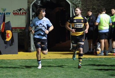 211125 - Newport RFC v Cardiff RFC, Super Rugbi Cymru - Sean Moore of Cardiff and Ben Roach of Newport lead the teams out as they both mark 100 appearances for their clubs