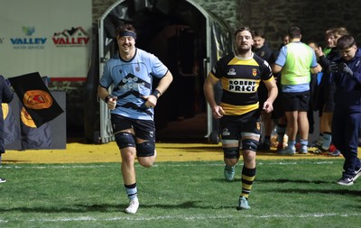 211125 - Newport RFC v Cardiff RFC, Super Rugbi Cymru - Sean Moore of Cardiff and Ben Roach of Newport lead the teams out as they both mark 100 appearances for their clubs