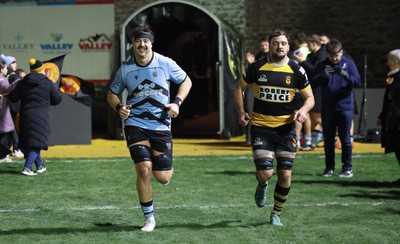 211125 - Newport RFC v Cardiff RFC, Super Rugbi Cymru - Sean Moore of Cardiff and Ben Roach of Newport lead the teams out as they both mark 100 appearances for their clubs