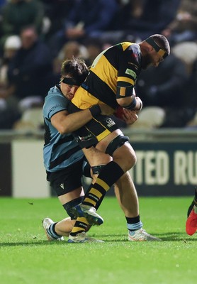 211125 - Newport RFC v Cardiff RFC, Super Rugbi Cymru - Josh Skinner of Newport is held by Sean Moore of Cardiff