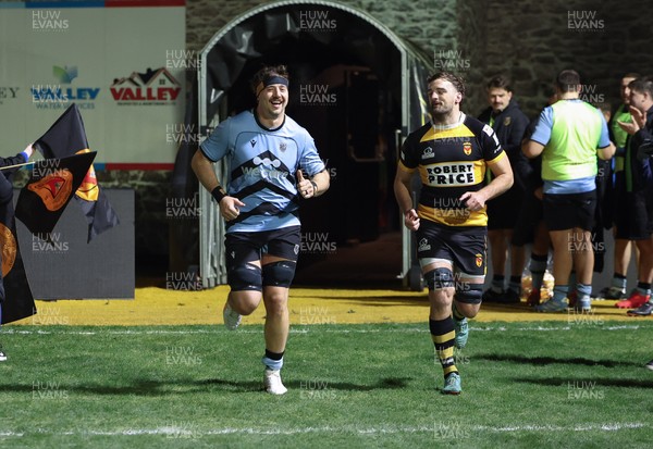 211125 - Newport RFC v Cardiff RFC, Super Rugbi Cymru - Sean Moore of Cardiff and Ben Roach of Newport lead the teams out as they both mark 100 appearances for their clubs