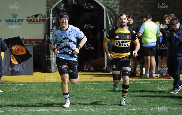 211125 - Newport RFC v Cardiff RFC, Super Rugbi Cymru - Sean Moore of Cardiff and Ben Roach of Newport lead the teams out as they both mark 100 appearances for their clubs