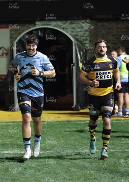 211125 - Newport RFC v Cardiff RFC, Super Rugbi Cymru - Sean Moore of Cardiff and Ben Roach of Newport lead the teams out as they both mark 100 appearances for their clubs