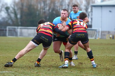 150225 - Newport RFC v Carmarthen Quins - Super Rygbi Cymru (SRC) - Barney Nightingale of Newport is tackled by Gabe McDonald (12) and Ellis Payne of Carmarthen