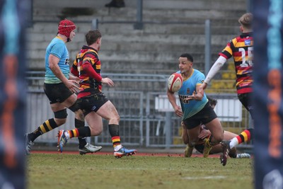 150225 - Newport RFC v Carmarthen Quins - Super Rygbi Cymru (SRC) - Ashton Hewitt of Newport offloads as Ellis Payne of Carmarthen tackles